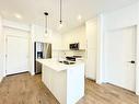 2116-111 Wolf Creek Drive Se, Calgary, AB  - Indoor Photo Showing Kitchen With Stainless Steel Kitchen With Double Sink 