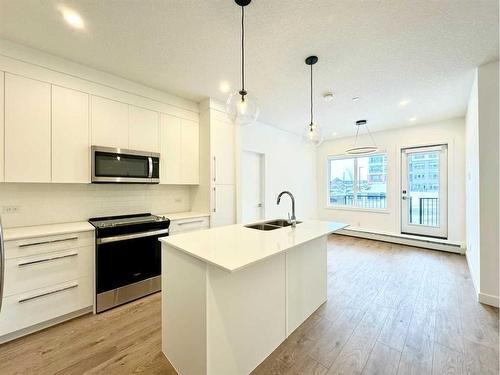 2116-111 Wolf Creek Drive Se, Calgary, AB - Indoor Photo Showing Kitchen With Double Sink With Upgraded Kitchen