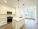 2116-111 Wolf Creek Drive Se, Calgary, AB  - Indoor Photo Showing Kitchen With Double Sink With Upgraded Kitchen 