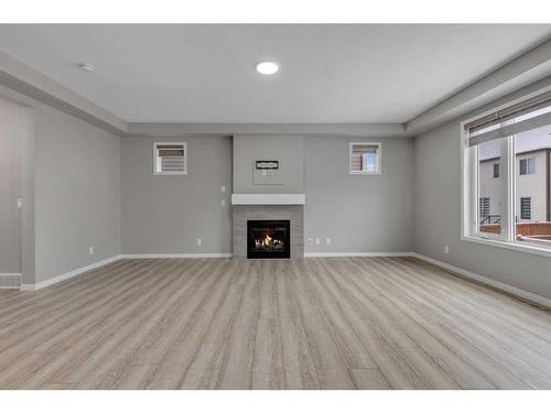 114 Osborne Common Sw, Airdrie, AB - Indoor Photo Showing Living Room With Fireplace