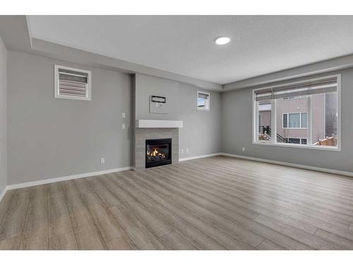 114 Osborne Common Sw, Airdrie, AB - Indoor Photo Showing Living Room With Fireplace