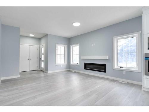 902 Macleod Trail Sw, High River, AB - Indoor Photo Showing Living Room With Fireplace