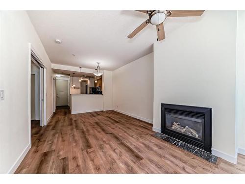 105-880 Centre Avenue Ne, Calgary, AB - Indoor Photo Showing Living Room With Fireplace