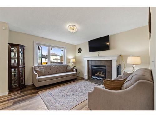 213 Saddlecrest Place Ne, Calgary, AB - Indoor Photo Showing Living Room With Fireplace