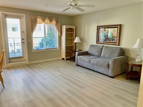 1108-928 Arbour Lake Road Nw, Calgary, AB - Indoor Photo Showing Living Room