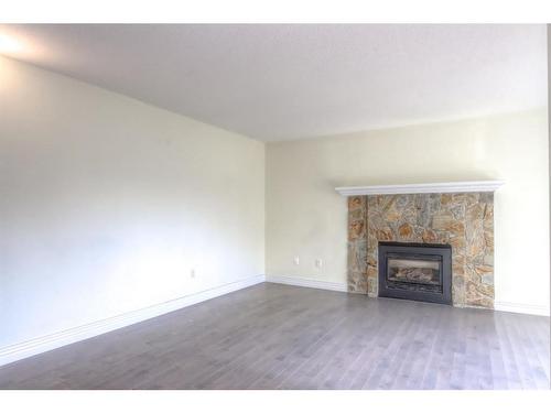 174-77 Glamis Green Sw, Calgary, AB - Indoor Photo Showing Living Room With Fireplace