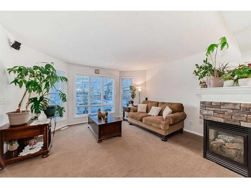 4 Saddlebrook Circle Ne, Calgary, AB - Indoor Photo Showing Living Room With Fireplace