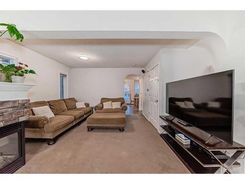 4 Saddlebrook Circle Ne, Calgary, AB - Indoor Photo Showing Living Room With Fireplace