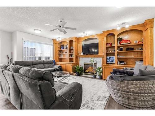 291 Taracove Estate Drive Ne, Calgary, AB - Indoor Photo Showing Living Room With Fireplace