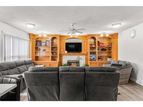 291 Taracove Estate Drive Ne, Calgary, AB - Indoor Photo Showing Living Room With Fireplace