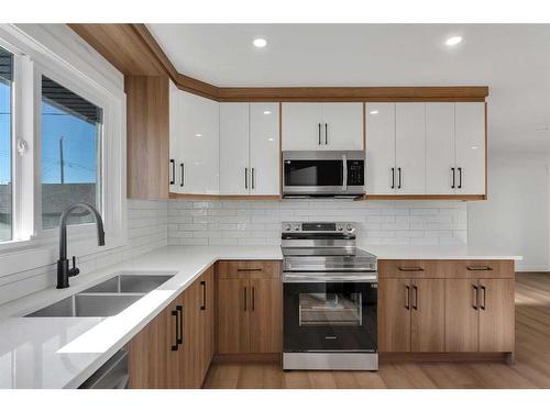 417 Huntley Way Ne, Calgary, AB - Indoor Photo Showing Kitchen With Double Sink