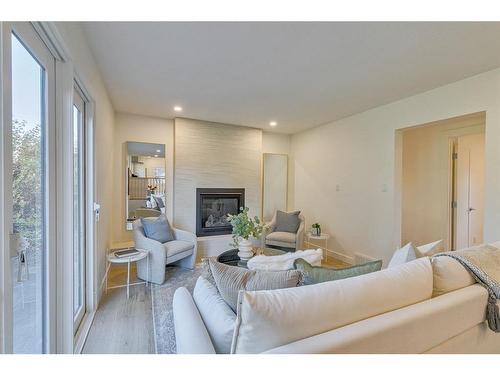 10727 Willowfern Drive Se, Calgary, AB - Indoor Photo Showing Living Room With Fireplace