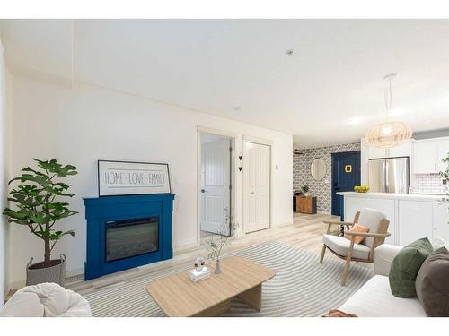 109-304 Cranberry Park Se, Calgary, AB - Indoor Photo Showing Living Room With Fireplace