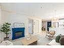 109-304 Cranberry Park Se, Calgary, AB  - Indoor Photo Showing Living Room With Fireplace 