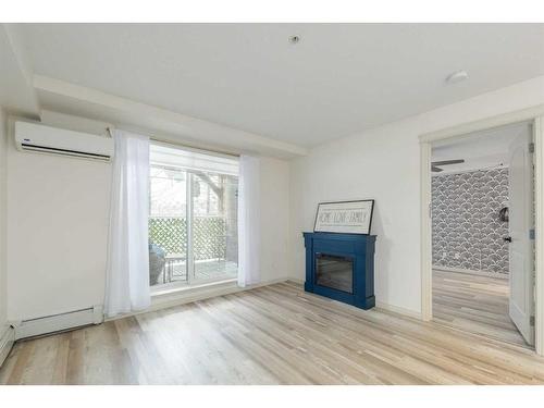 109-304 Cranberry Park Se, Calgary, AB - Indoor Photo Showing Living Room With Fireplace