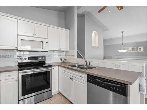 106 Creek Gardens Place Nw, Airdrie, AB - Indoor Photo Showing Kitchen With Double Sink