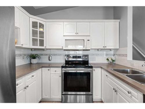 106 Creek Gardens Place Nw, Airdrie, AB - Indoor Photo Showing Kitchen With Double Sink