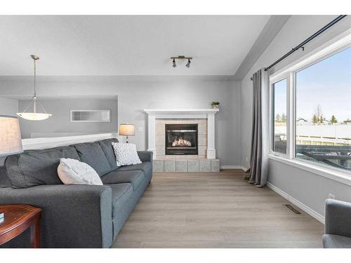 106 Creek Gardens Place Nw, Airdrie, AB - Indoor Photo Showing Living Room With Fireplace