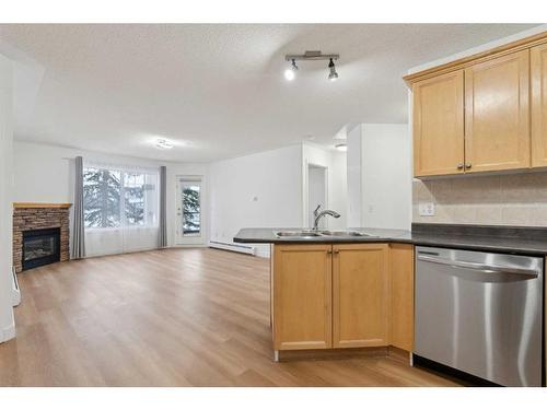 212-345 Rocky Vista Park Nw, Calgary, AB - Indoor Photo Showing Kitchen With Fireplace With Double Sink