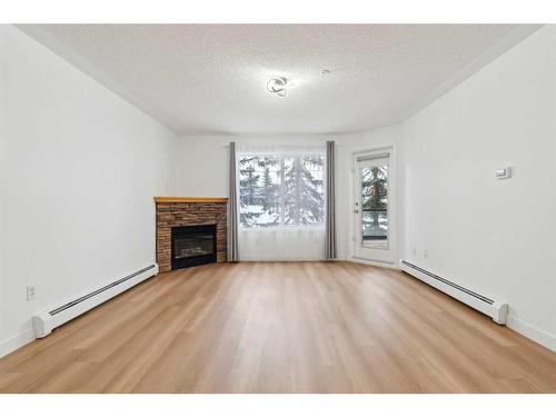 212-345 Rocky Vista Park Nw, Calgary, AB - Indoor Photo Showing Living Room With Fireplace