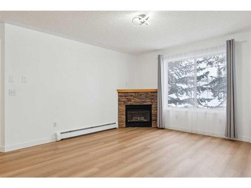 212-345 Rocky Vista Park Nw, Calgary, AB - Indoor Photo Showing Living Room With Fireplace