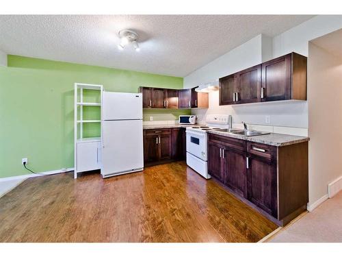 17 Tuscany Valley Park Nw, Calgary, AB - Indoor Photo Showing Kitchen With Double Sink