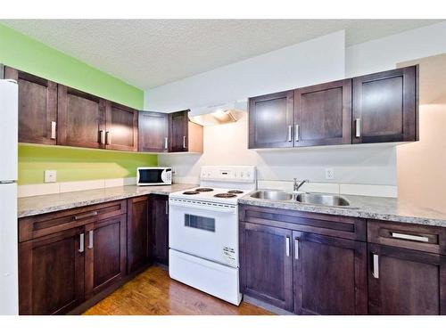 17 Tuscany Valley Park Nw, Calgary, AB - Indoor Photo Showing Kitchen With Double Sink