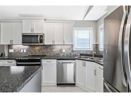 336 Willow Ridge Manor, Diamond Valley, AB - Indoor Photo Showing Kitchen With Stainless Steel Kitchen With Double Sink With Upgraded Kitchen