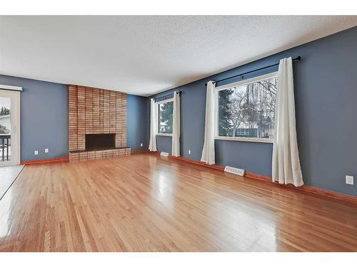 9927 5 Street Se, Calgary, AB - Indoor Photo Showing Living Room With Fireplace