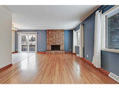 9927 5 Street Se, Calgary, AB - Indoor Photo Showing Living Room With Fireplace