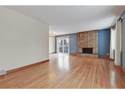 9927 5 Street Se, Calgary, AB - Indoor Photo Showing Living Room With Fireplace