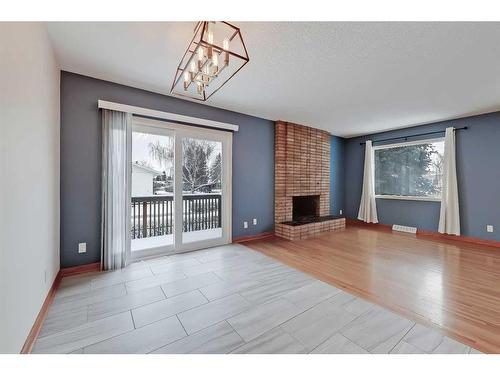 9927 5 Street Se, Calgary, AB - Indoor Photo Showing Living Room With Fireplace