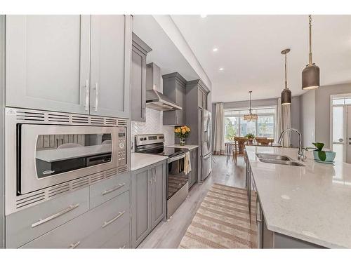 148 Dawson Drive, Chestermere, AB - Indoor Photo Showing Kitchen With Double Sink With Upgraded Kitchen