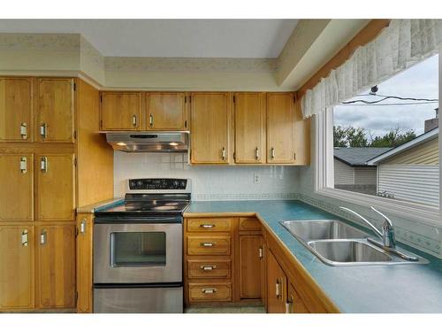 9831 Alcott Road Se, Calgary, AB - Indoor Photo Showing Kitchen With Double Sink