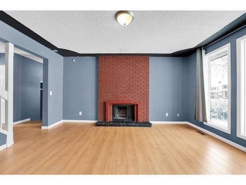 50 Pinelore Place Ne, Calgary, AB - Indoor Photo Showing Living Room With Fireplace