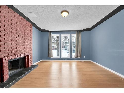 50 Pinelore Place Ne, Calgary, AB - Indoor With Fireplace