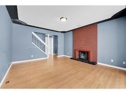 50 Pinelore Place Ne, Calgary, AB - Indoor Photo Showing Other Room With Fireplace