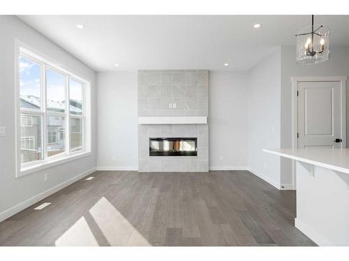 200 Precedence Hill, Cochrane, AB - Indoor Photo Showing Living Room With Fireplace