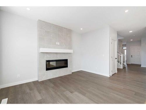 200 Precedence Hill, Cochrane, AB - Indoor Photo Showing Living Room With Fireplace