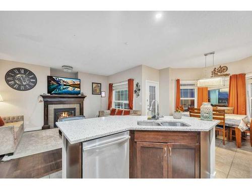 28 Saddlebrook Landing Ne, Calgary, AB - Indoor Photo Showing Kitchen With Fireplace With Double Sink