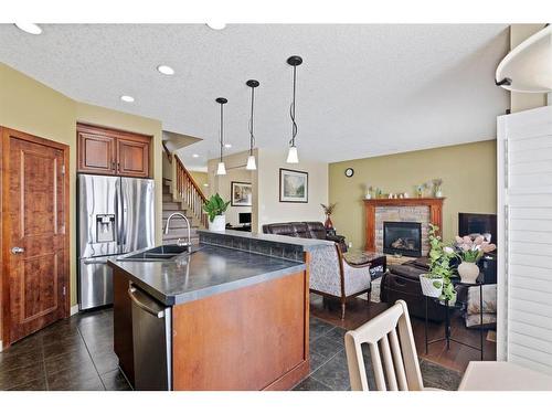 173 Everoak Circle Sw, Calgary, AB - Indoor Photo Showing Kitchen With Fireplace With Double Sink