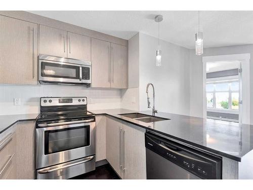 1403-11 Mahogany Row Se, Calgary, AB - Indoor Photo Showing Kitchen With Double Sink With Upgraded Kitchen