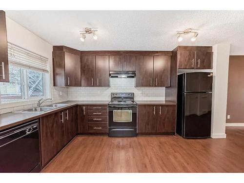 1703-2445 Kingsland Road Se, Airdrie, AB - Indoor Photo Showing Kitchen With Double Sink