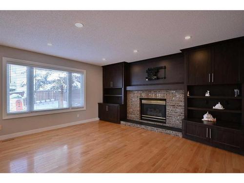 8 Arbour Glen Close Nw, Calgary, AB - Indoor Photo Showing Living Room With Fireplace