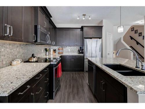 239 Sunset Point, Cochrane, AB - Indoor Photo Showing Kitchen With Double Sink With Upgraded Kitchen