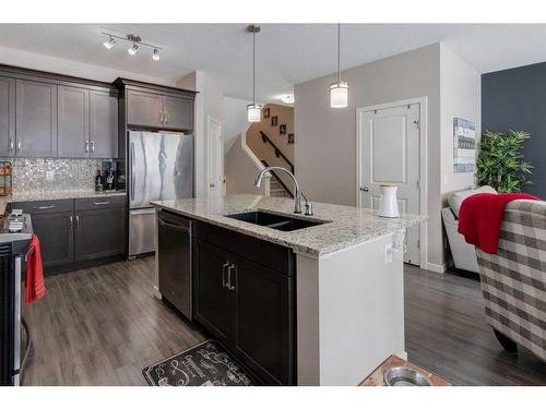 239 Sunset Point, Cochrane, AB - Indoor Photo Showing Kitchen With Stainless Steel Kitchen With Double Sink With Upgraded Kitchen