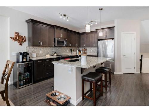 239 Sunset Point, Cochrane, AB - Indoor Photo Showing Kitchen With Stainless Steel Kitchen With Upgraded Kitchen