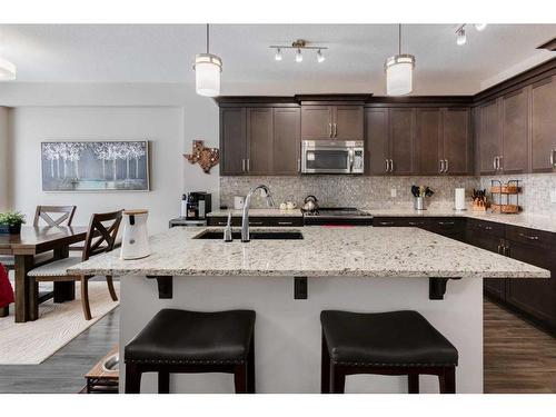 239 Sunset Point, Cochrane, AB - Indoor Photo Showing Kitchen With Upgraded Kitchen