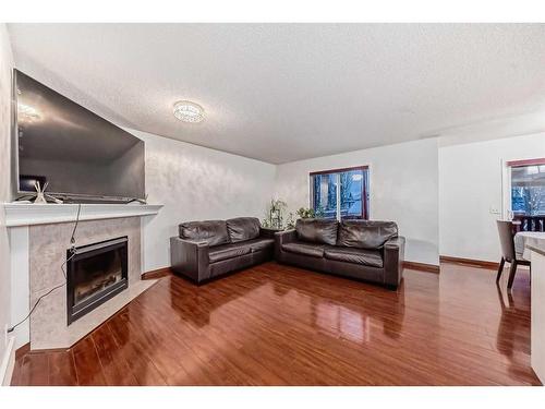 37 Somerside Crescent Sw, Calgary, AB - Indoor Photo Showing Living Room With Fireplace