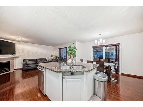 37 Somerside Crescent Sw, Calgary, AB - Indoor Photo Showing Kitchen With Fireplace With Double Sink